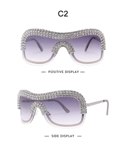 Macro view of crystal-encrusted oversized punk sunglasses with purple gradient lenses