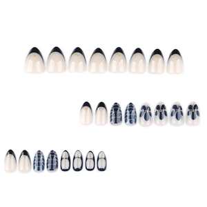 Short oval fake nails set featuring navy blue french tips and delicate floral designs