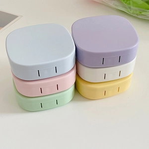 Close-up of compact macaron-colored contact lens cases with matte finish on white background