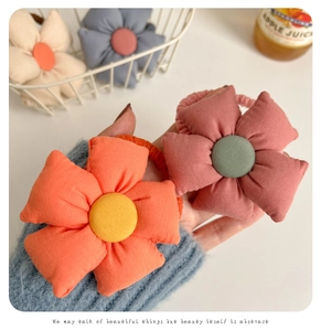 Close-up of soft fabric sunflower hair ties in various Morandi colors for young girls