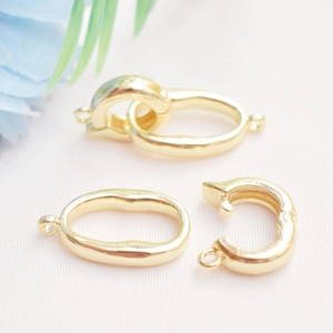 Macro shot of 14K gold-filled oval pearl clasps with spring mechanism for DIY necklaces