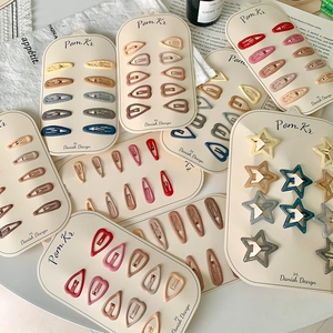 Colorful set of cute heart and star hair clips for girls with matte and glitter finishes
