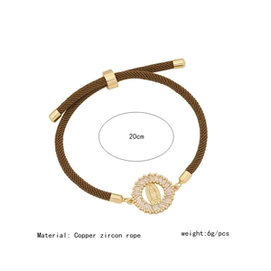 Detailed view of religious braided bracelet with copper zircon charm and 20cm circumference