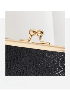 Detail of black woven texture and polished gold metal clasp on a vintage coin purse