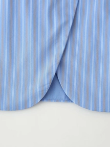 Detail view of the curved hem and blue striped fabric texture on sleeveless vest top