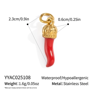 Detail of red enamel Italian horn pendant with golden crown and stainless steel ring
