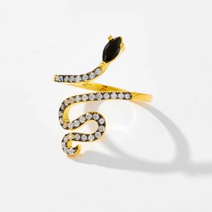 Detailed view of golden snake ring with black marquise stone and zircon micro-paving
