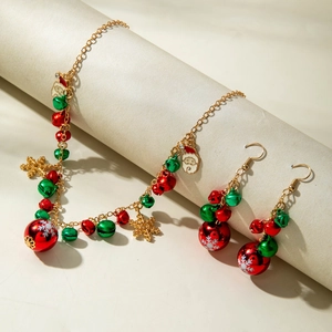 Detailed view of Christmas jewelry set with festive red and green bells and Santa charm