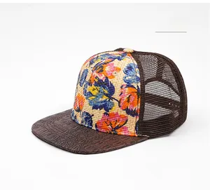Detail of floral straw weave and brown crocodile pattern leather on the baseball cap brim