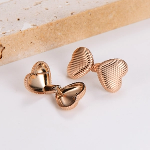 Rose gold heart-shaped hoop earrings with elegant vertical striped texture design