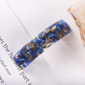 Close-up of rectangular acetate spring hair clip with blue and brown tortoiseshell pattern
