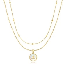 Detailed close-up of a double-layer gold snake chain necklace with pearl letter A pendant