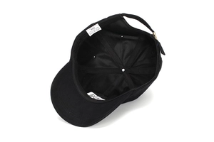 Internal view of black cotton baseball cap showing sweatband and adjustable metal buckle