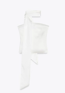 Detail of elegant white satin bandeau top featuring a long neck scarf attachment
