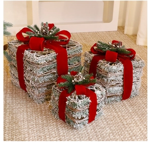 Three-piece beige Christmas gift box set with velvet bows and natural pine cones