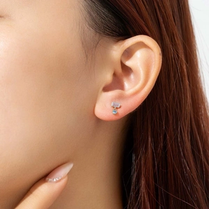 Elegant 925 silver studs featuring pink rectangle and blue round stones on model