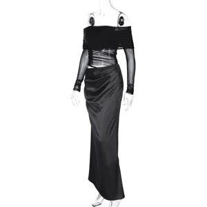 Detail of black mesh off-shoulder long sleeve top and high waist pleated maxi skirt set