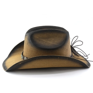 Detail of woven straw cowboy hat featuring faux leather band and turquoise accent