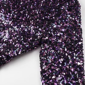 Elegant deep purple sequined party dress with long sleeves and reflective shimmering finish