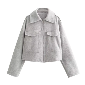 Detailed flat lay of grey tweed cropped jacket featuring zipper closure and large pockets