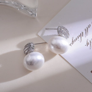 Detailed macro view of French vintage pearl earrings with micro-set crystals