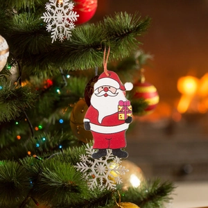 Cartoon gnome wooden Christmas tree ornaments in red and white hanging on a festive tree
