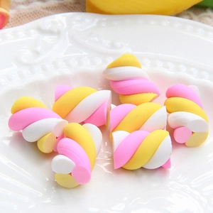 Colorful twisted marshmallow clay charms in yellow, pink and white for DIY crafts