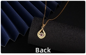 Back view of gold-plated teardrop pendant with round purple zircon and hollow out design