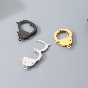 Detailed view of handcuff-shaped jewelry clasps in black, silver, and gold finishes