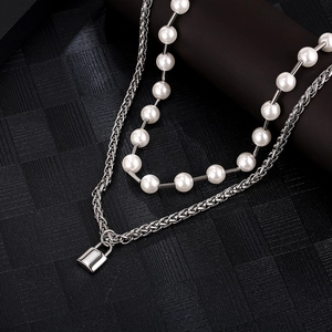 Double-layer necklace with silver keel chain, small lock pendant and white pearls