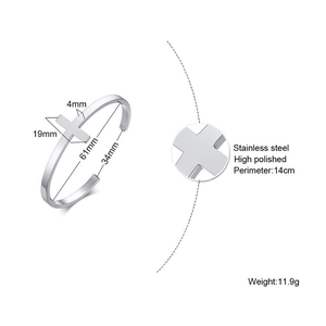 Detailed view of silver stainless steel cuff bracelet with cross motif and size specs