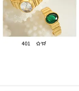 Close-up of vintage textured gold rings with emerald green stone and sparkling zircon