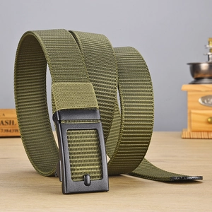 Close-up of olive green nylon tactical belt with matte black metal buckle on wood