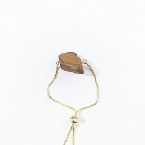 Detail of adjustable golden box chain with raw natural brown crystal mineral stone