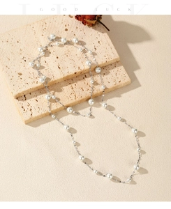 Detailed view of elegant S925 silver necklace with lustrous pearls on stone surface