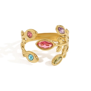 18K gold leaf ring featuring colorful rainbow zircons on a minimalist open band