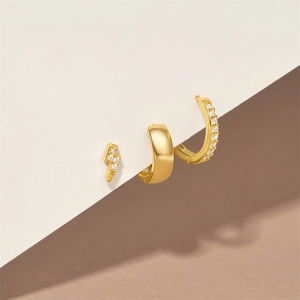 Detailed view of 3-piece gold earring set with lightning bolt and zircon on display card