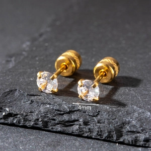 Close-up of 4mm gold-plated stainless steel stud earrings with zircon on black stone