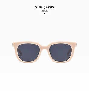 Detail view of beige square frame sunglasses with silver rivet accents and dark lenses