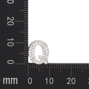 Detail view of a zircon-encrusted letter Q pendant with dimensions 15mm by 12mm
