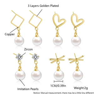 Detailed view of four 18k gold plated earrings featuring zircon, pearl, heart and bow designs