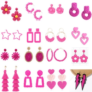 Collection of pink earrings featuring flowers, hearts, and stars in a neat grid display
