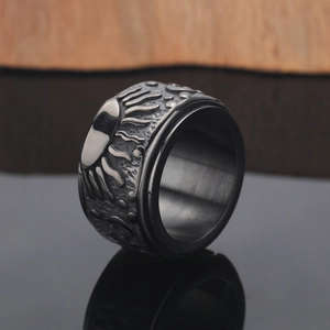 Close-up of vintage rotating spinner ring with sun relief and hammered texture surface