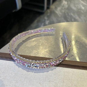 Detailed macro view of sparkling pink and silver crystal rhinestones on a metal headband