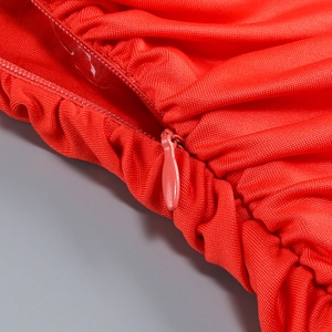 Close-up of invisible zipper and fine knit texture on red sexy party dress