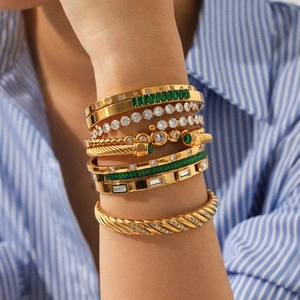 Gold stainless steel bangle set featuring cable textures and green zircon accents