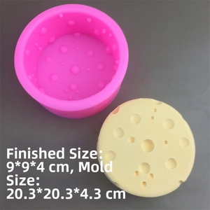 Detail of round pink silicone cheese mold with finished yellow sponge texture product