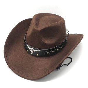 Close-up of brown suede cowboy hat featuring metal bull head and leather band
