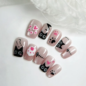 Cat-themed cat eye press-on nails with cute black kitten, paw prints, and fishbone designs