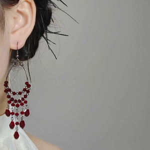 Elegant red faceted glass bead tassel drop earrings with silver chain and ethnic style design